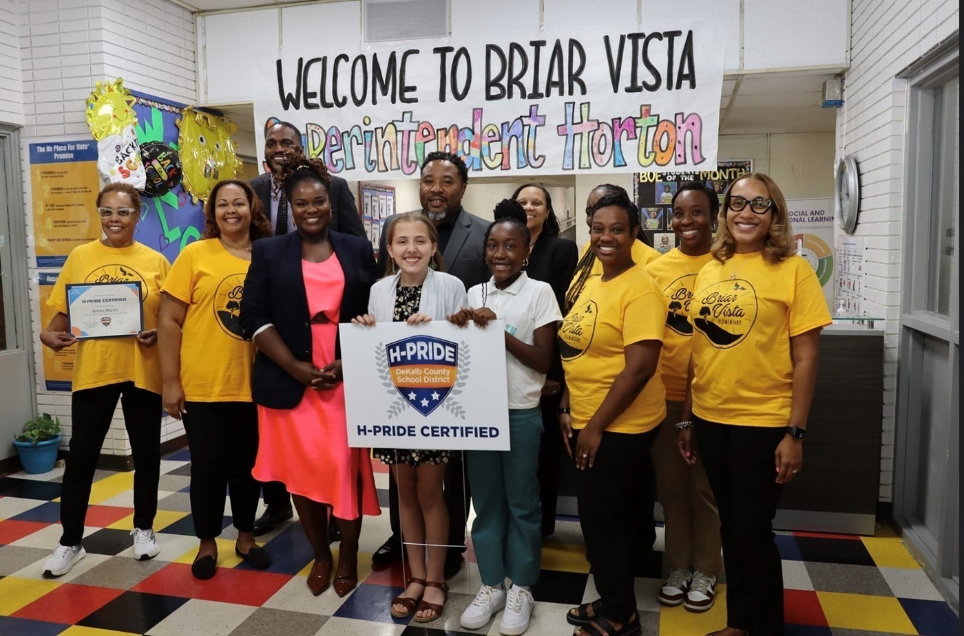 Briar Vista Staff, DCSD Superintendent, and students in yellow tshirts