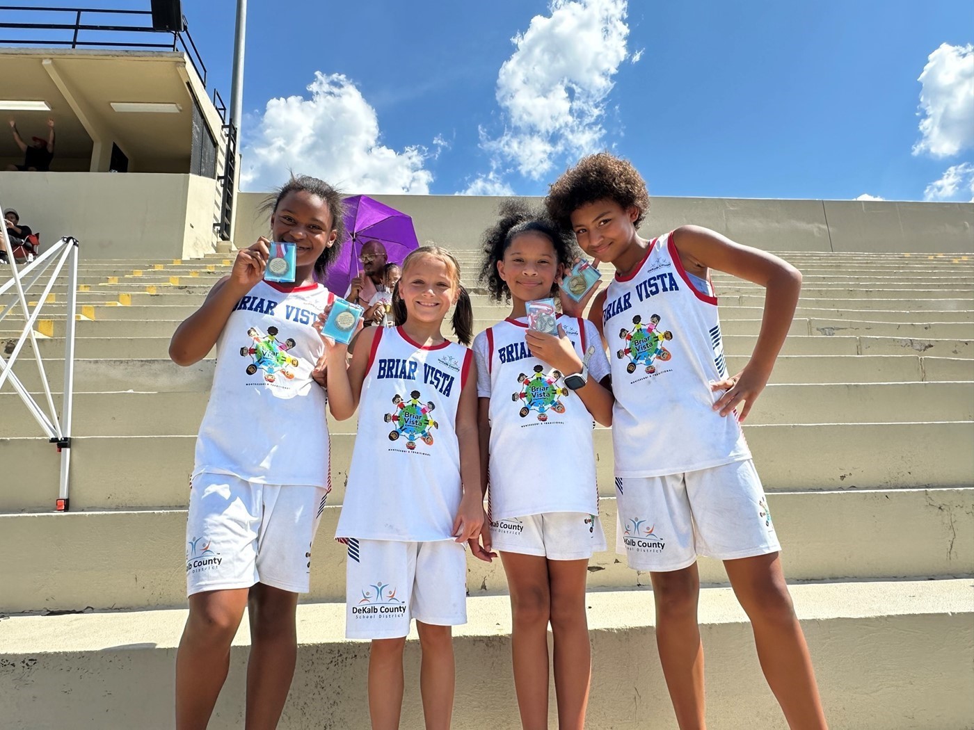 4 girls in school track uniforms